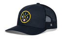 The Haka Hat Milwaukee Trucker Hat | MIL X Baseball Snapback is a black mesh trucker hat by Haka Hat, featuring a yellow circular embroidered MIL X patch on the front with "M I L" lettering and a small baseball graphic at the center.