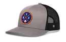 The Haka Hat New York Trucker Hat | NYC X Baseball Snapback features gray and black mesh, a circular blue patch with orange edges, orange NYC letters, a white baseball icon, and a comfort-fit sweatband for all-day wear.