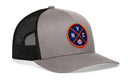 The Haka Hat New York Trucker Hat is a gray and black snapback with a round patch showing NYC letters over a baseball in a navy circle with an orange border. Features include a comfort-fit sweatband for all-day wear.
