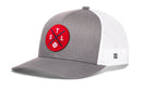 The Haka Hat St Louis Trucker Hat by Haka Hat is a gray and white STL X baseball snapback with a mesh back and a front round red patch featuring crossed bats, S, T, L letters, and a white baseball for classic style.