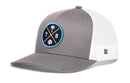 The Haka Hat Tampa Bay Trucker Hat is a gray and white snapback with mesh back, featuring a round patch displaying crossed yellow and blue lines, a palm tree, the letters T and B, and a baseball—perfect for Tampa Bay fans.