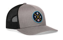 The Haka Hat Tampa Bay Trucker Hat is a gray and black snapback with mesh back and a round patch featuring a palm tree, yellow crossed bats, baseball, and TB—ideal for any Tampa Bay hat collection.