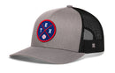 The Haka Hat Texas Trucker Hat | TEX X Baseball Snapback features a grey front with a circular TEX and baseball patch on blue, red trim, black mesh back, and classic snapback closure.