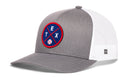 The Haka Hat Texas Trucker Hat | TEX X Baseball Snapback by Haka Hat is a gray and white mesh-back trucker hat with a round blue, red, and white front patch featuring TEX and a baseball graphic.