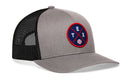 The Haka Hat Texas Trucker Hat features a gray and black mesh snapback design with a round navy patch on the front displaying red "TEX," a white baseball, and red X lines. Brand: Haka Hat. Model: TEX X Baseball Snapback.