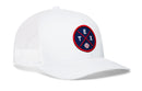 The Haka Hat Texas Trucker Hat features white mesh and a front round navy and red patch with “TEX” lettering and a small baseball graphic.