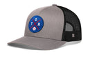 The Haka Hat Toronto Trucker Hat is a gray and black mesh snapback featuring a round blue patch with a red and white baseball and TOR letters around crossed red lines.