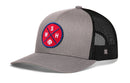 The Haka Hat Washington DC Trucker Hat features gray fabric, a curved bill, black breathable mesh back, and a red-blue circular WSH X baseball patch on the front.