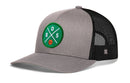 The Haka Hat Boston Trucker Hat is a gray and black mesh snapback featuring a green BOS X Basketball patch with crossed white lines, an orange basketball, and classic Haka Hat style.