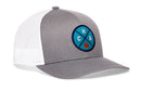 The Haka Hat Charlotte Trucker Hat features a gray and white design, a circular blue "CHA" patch with an orange basketball, and a snapback fit. Stylish and sporty, it's part of the CHA X Basketball Snapback collection by Haka Hat.