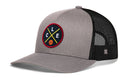 The Haka Hat Cleveland Trucker Hat features gray and black mesh, a curved brim, a round patch with yellow crossed lines, letters L, C, E, and a small basketball—CLE X Basketball Snapback by Haka Hat.