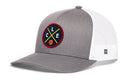 The Haka Hat Cleveland Trucker Hat | CLE X Basketball Snapback is a gray and white mesh-back hat with a round front patch showing C, L, E letters, a basketball, and crossed yellow lines.