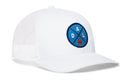 The Haka Hat Dallas Trucker Hat is a white mesh-back snapback with a blue circular patch featuring “DAL” and a small orange basketball on the front.