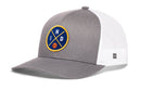 The Haka Hat Indiana Trucker Hat is a gray and white mesh-back snapback featuring a circular blue and yellow patch with "ND" and a small basketball on the front. Brand: Haka Hat.
