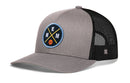 The Haka Hat Memphis Trucker Hat, a MEM X Basketball Snapback, features a gray and black design with mesh back and an embroidered patch showing crossed yellow lines, E and M letters, and a small orange basketball.