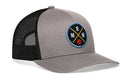 The Haka Hat Memphis Trucker Hat | MEM X Basketball Snapback features a gray and black mesh design with a circular patch showcasing yellow, blue, and white E, M, M letters intersected by lines and a small orange basketball.