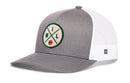 The Haka Hat Milwaukee Trucker Hat is a gray and white snapback with mesh back, featuring an embroidered patch with green "M" and "L," crossed lines, and an orange basketball at the center.