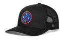 The Haka Hat New York Trucker Hat by Haka Hat is a black mesh trucker cap with a curved brim and a round blue patch on the front featuring “NYC” and an orange and white basketball.