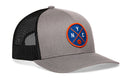 The Haka Hat New York Trucker Hat features gray and black mesh, a round blue patch with orange trim, crossed lines, NYC letters, and an orange basketball on the front.