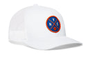 The Haka Hat New York Trucker Hat is a white mesh snapback with a curved brim, featuring a round blue front patch embroidered with NYC in orange and white and a small basketball at the bottom.