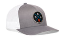 The Haka Hat Orlando Trucker Hat features a gray and white design with a mesh back and a front circular patch showing blue crossed lines, the letters ORL, and a small orange basketball.