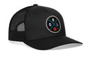 The Haka Hat Orlando Trucker Hat is a black snapback with a mesh back, featuring a round front patch with blue and black crossed lines, “ORL” letters, and a small orange basketball.
