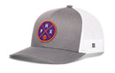 The Haka Hat Phoenix Trucker Hat features a gray front and brim, white mesh back, and a round purple and orange PHX basketball logo. This stylish snapback is perfect for any fan. Brand: Haka Hat.