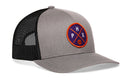 The Haka Hat Phoenix Trucker Hat features a gray and black design, mesh back, snapback closure, and a round purple patch with orange and white PHX letters plus a small basketball graphic. Classic HAKA 5.0 style.