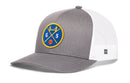 The Haka Hat San Francisco Trucker Hat by Haka Hat features a gray and white design, mesh back, curved brim, and a blue patch with crossed yellow lines, "GS", a bridge, and an orange basketball on the front.
