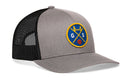 The Haka Hat San Francisco Trucker Hat is a gray and black snapback by Haka Hat, featuring a blue and yellow round patch with "G" and "S," a bridge, crossed paddles, and a red basketball on the front.
