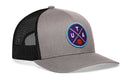 The Haka Hat Utah Trucker Hat is a gray and black snapback with a mesh back and a circular patch on the front featuring UTA letters and a small basketball on a purple background.