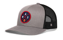 The Haka Hat Washington DC Trucker Hat features a mesh back, gray and black snapback design, and a front patch with intersecting red lines, WAS letters, and an orange basketball.