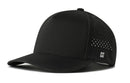 The Haka Hat Blank Performance 5-Panel Hat by Haka Hat features a black design, curved brim, side ventilation holes, Flexfit® sweatband for comfort, snapback closure, and a stitched H logo near the back.
