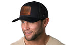 A man wears the Haka Hat Don't Tread on Me American Flag Trucker Hat, featuring a black Gadsden leather patch, from Haka Hat.