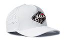 White Haka Hat HAKA Golf Performance 5-Panel Hat with a perforated back and a diamond-shaped logo on the front featuring the word Haka and crossed golf clubs.
