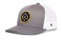 Introducing the Haka Hat Boston Hockey Trucker Hat | BOS X Snapback—a gray and white mesh trucker hat from Haka Hat featuring a snapback closure. This hat displays a round patch on the front with two crossed hockey sticks, a puck, and the letters BOS.