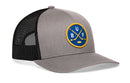 Gray and black Haka Hat Buffalo Hockey Trucker Hat | BUF X snapback featuring a circular patch with crossed hockey sticks, a puck, and the letters BUF.
