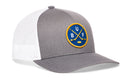 Haka Hat Buffalo Hockey Trucker Hat featuring a grey and white design with a round blue patch containing yellow crossed hockey sticks, a hockey puck, and the letters B, U, and F.