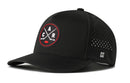 Introducing the Haka Hat Carolina Hockey Performance 5-Panel Hat in Black, featuring a red and white circular patch with crossed hockey sticks and the C and A letters, perforated side panels for breathability, a Flexfit snapback closure for all-day comfort, and a subtle H logo on the left—an essential addition to any Carolina hockey hat collection.