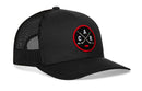 Introducing the Haka Hat Carolina Hockey Trucker Hat | Black CAR X Snapback by Haka Hat—a black mesh trucker hat featuring a round patch with crossed hockey sticks and the letters C, A, and R, highlighted by a red border and puck. Designed in Haka’s signature 5.0 trucker style, this North Carolina-inspired cap combines comfort with classic sport-inspired flair.
