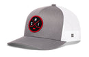 The Haka Hat Chicago Hockey Trucker Hat | CHI X Snapback by Haka Hat is a gray and white mesh baseball cap featuring a round black and red embroidered patch with red crossed bats, a baseball, and the letters C H I.