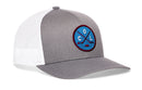 Haka Hat Colorado Hockey Trucker Hat gray cap with a white mesh back and a circular COL X embroidered patch on the front featuring crossed hockey sticks and a puck.