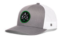 Introducing the Haka Hat Dallas Hockey Trucker Hat | DAL X Snapback—a gray and white snapback featuring a round green and black embroidered DAL X patch with crossed hockey sticks and the letters D A L. This Haka Hat design has a gray bill and front panel, complemented by a white mesh back—an ideal addition to any Dallas hockey hat collection.