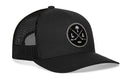 Black Haka Hat Los Angeles Hockey Trucker Hat with a circular patch featuring two crossed hockey sticks, a palm tree, a hockey puck, and the letters L and A.