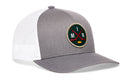 The Haka Hat Minnesota Hockey Trucker Hat | MIN X Snapback by Haka Hat is a gray and white trucker cap inspired by Minnesota hockey. It features a round patch with crossed red hockey sticks, the letters M and N, and a small yellow puck set against a dark green background. This Haka signature 5.0 trucker hat is ideal for fans seeking that classic Minneapolis snapback style.