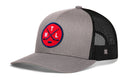 Introducing the Haka Hat Montreal Hockey Trucker Hat | MTL X Snapback: a gray and black mesh trucker cap by Haka Hat, featuring a round red patch with crossed hockey sticks and the letters “MTL” on the front. This Montreal hockey hat offers a curved brim, structured front panel, and an adjustable snapback closure for a comfortable fit.