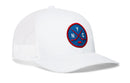 The Haka Hat New York Hockey Trucker Hat | NYC X Snapback is a white mesh snapback trucker hat featuring a blue and red circular patch on the front with NYC and two crossed hockey sticks, making it a must-have for fans of city sports style.