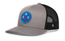 Haka Hat Quebec Hockey Trucker Hat featuring a grey and black design with a blue circular patch containing the letters QBC and crossed hockey sticks.