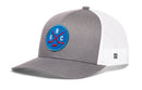 Haka Hat Quebec Hockey Trucker Hat | QBC X Snapback in grey and white, featuring a blue circular patch with the letters Q, B, and C arranged around two crossed red hockey sticks and a puck.
