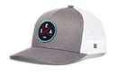 Introducing the Haka Hat Seattle Hockey Trucker Hat | SEA X Snapback by Haka Hat—a gray and white snapback featuring a round patch with crossed oars and the letters S, E, A. The front panel and bill are solid gray, while the back is made from white mesh, combining classic style with comfort in this signature 5.0 trucker design.